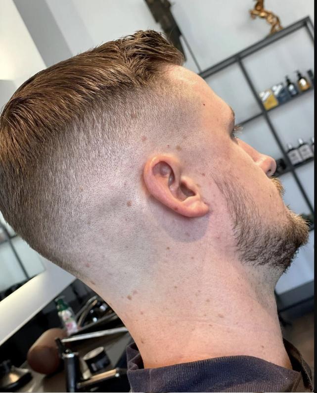 A high skin fade in profile, cut at AMIN